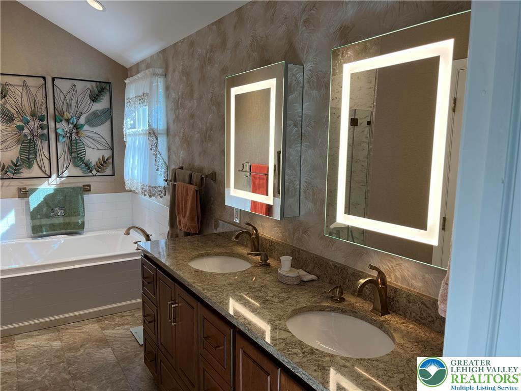 205 Spyglass Hill Road Bath, PA 18014 - Photo 23 of 51 a bathroom with a granite countertop sink and a mirror