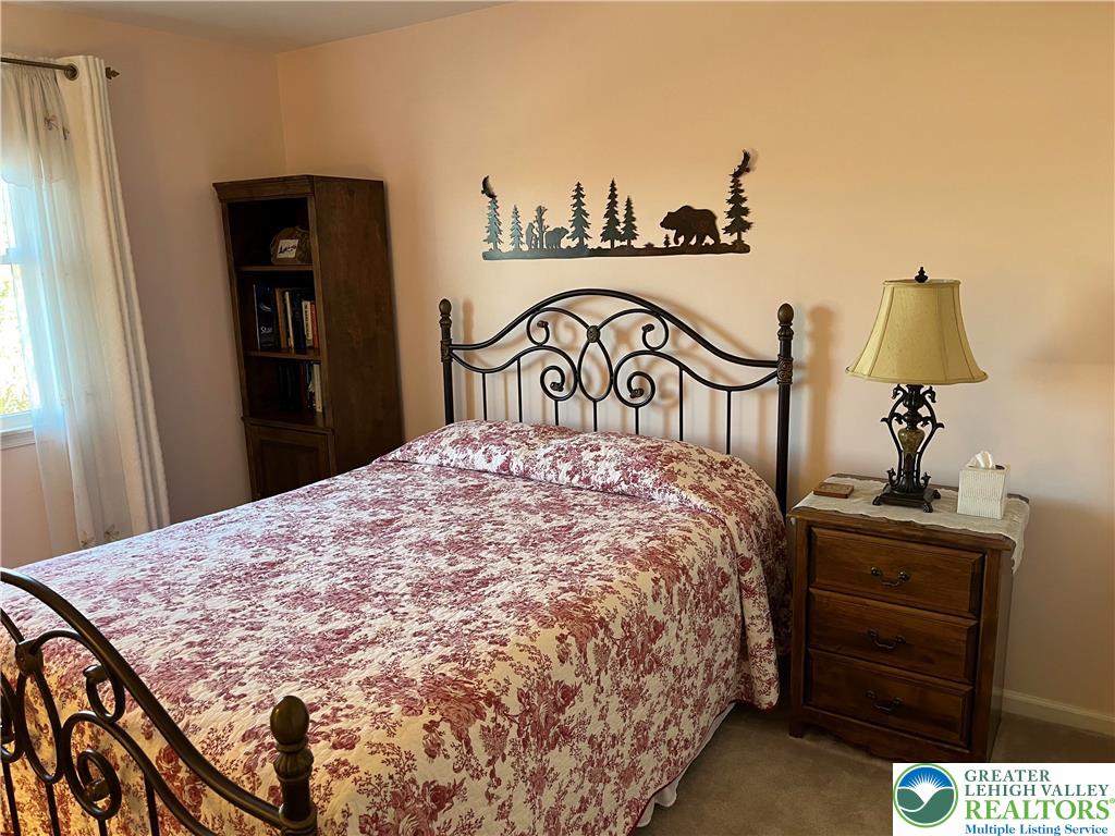 205 Spyglass Hill Road Bath, PA 18014 - Photo 30 of 51 a bedroom with a bed and a lamp on dresser