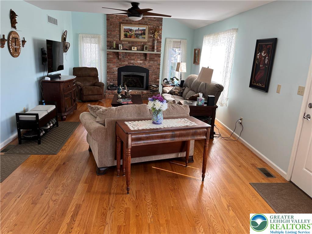 205 Spyglass Hill Road Bath, PA 18014 - Photo 6 of 51 a living room with furniture a flat screen tv and a fireplace