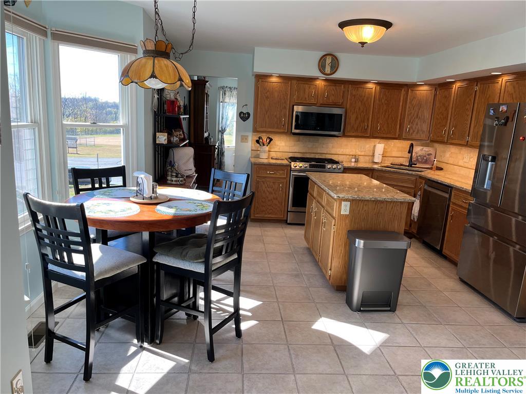 205 Spyglass Hill Road Bath, PA 18014 - Photo 8 of 51 a kitchen with a table chairs and microwave
