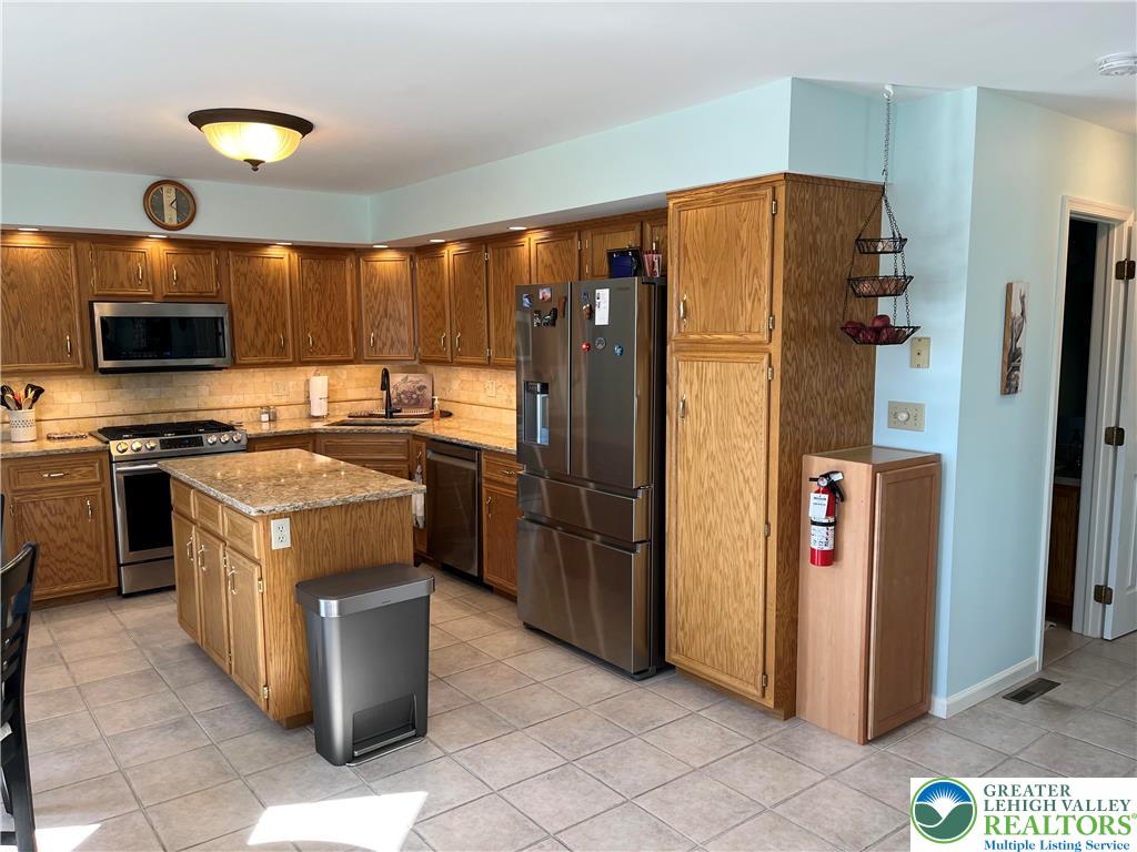 205 Spyglass Hill Road Bath, PA 18014 - Photo 9 of 51 a kitchen with stainless steel appliances granite countertop a refrigerator and a stove