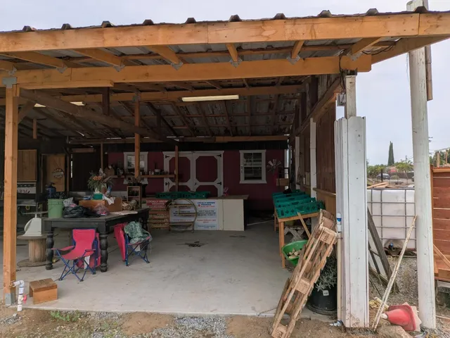 a view of a patio with table and chairs potted plants with wooden floor