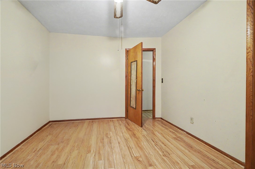 4250 Herr Fieldhouse Road Southington, OH 44470 - Photo 16 of 50 Room featuring wood-finish flooring, light-toned walls, and wood trim