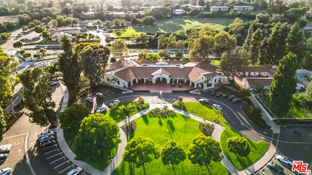 an aerial view of residential houses with outdoor space and swimming pool