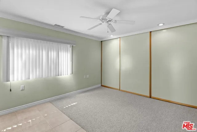 view of an empty room with closet and bathroom