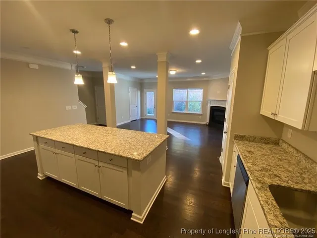 a spacious bathroom with a granite countertop sink a large mirror and a shower
