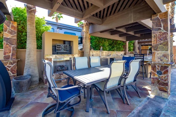 a view of an outdoor dining space with a table and chairs