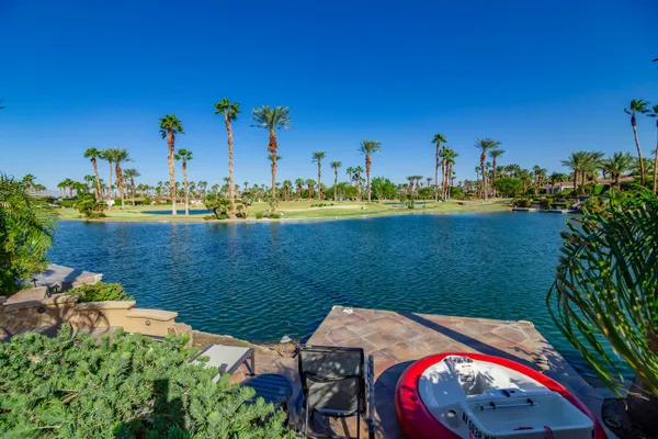 a view of a lake with a table and chairs