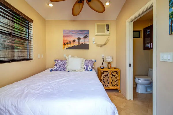 a bedroom with a bed and dresser with mirror