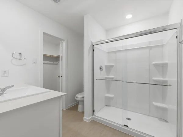 a bathroom with a shower and a sink