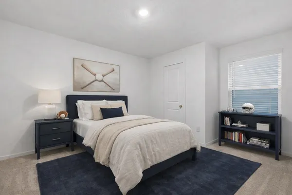 a bedroom with a bed and window