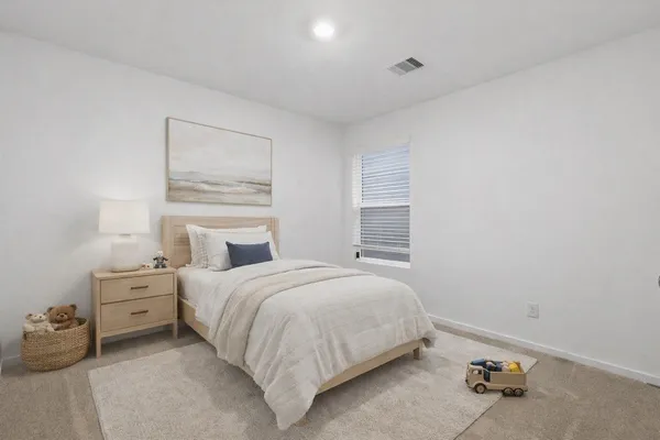 a bedroom with a bed and a window