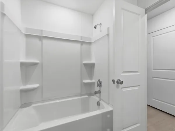 a white bath tub sitting next to a white toilet