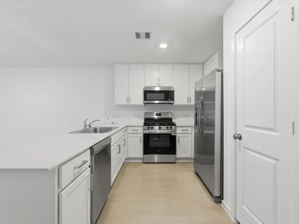 a kitchen with a sink a stove and refrigerator