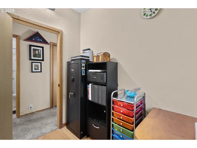 a living room with a book shelf and a table