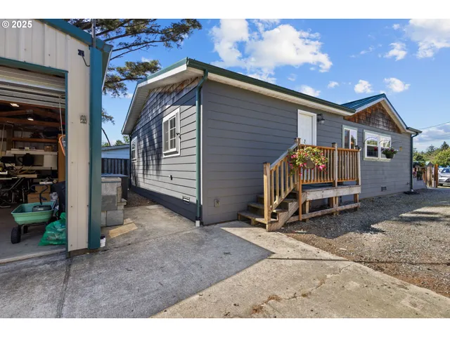 a view of backyard with a barn and a car parked in it