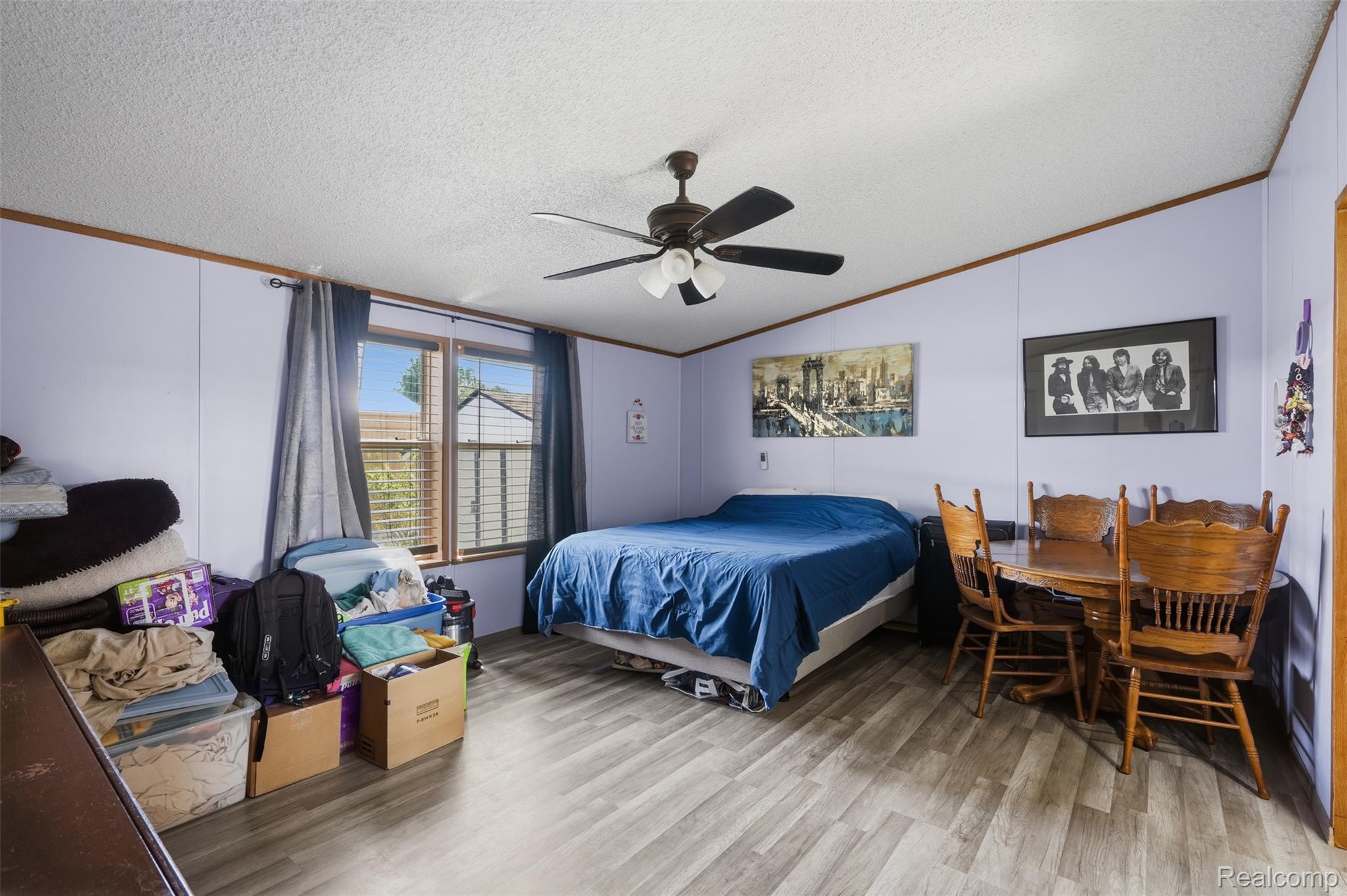 4634 Butternut Street Clarkston, MI 48348 - Photo 15 of 28 Spacious room featuring wood-finish flooring and light purple walls with wood trim