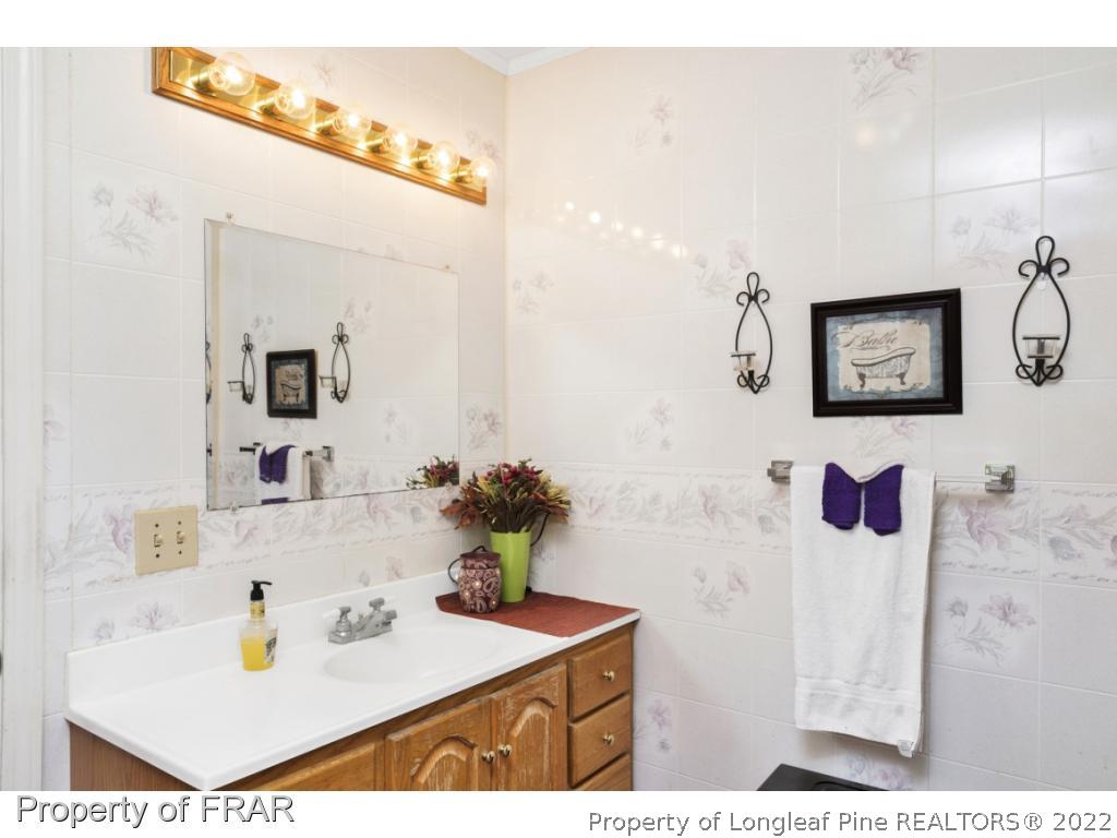 5253 Lobelia Road Vass, NC 28394 - Photo 16 of 28 a bathroom with a sink vanity and a mirror