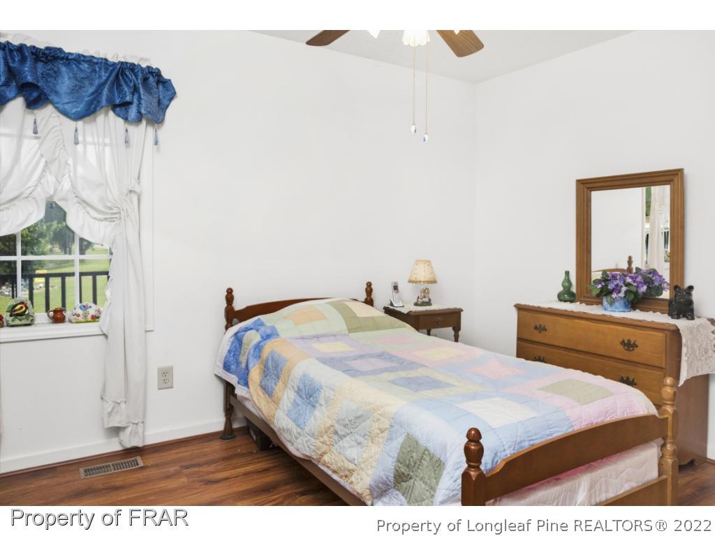 5253 Lobelia Road Vass, NC 28394 - Photo 18 of 28 a bedroom with double bed and a window