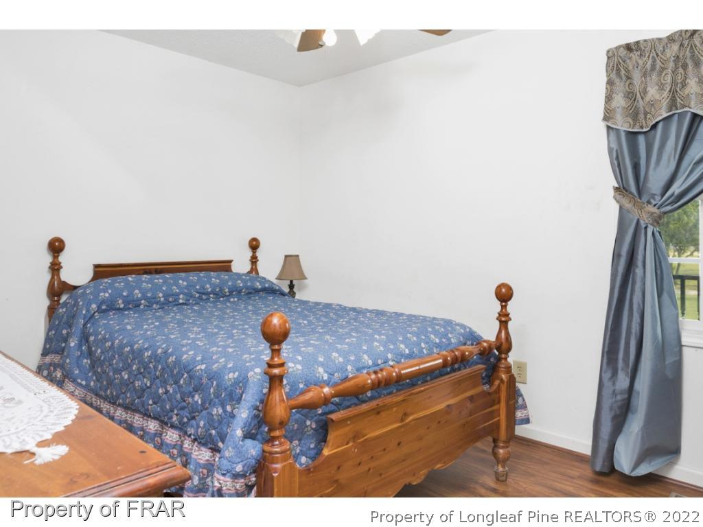 5253 Lobelia Road Vass, NC 28394 - Photo 20 of 28 a bedroom with a bed and a rug