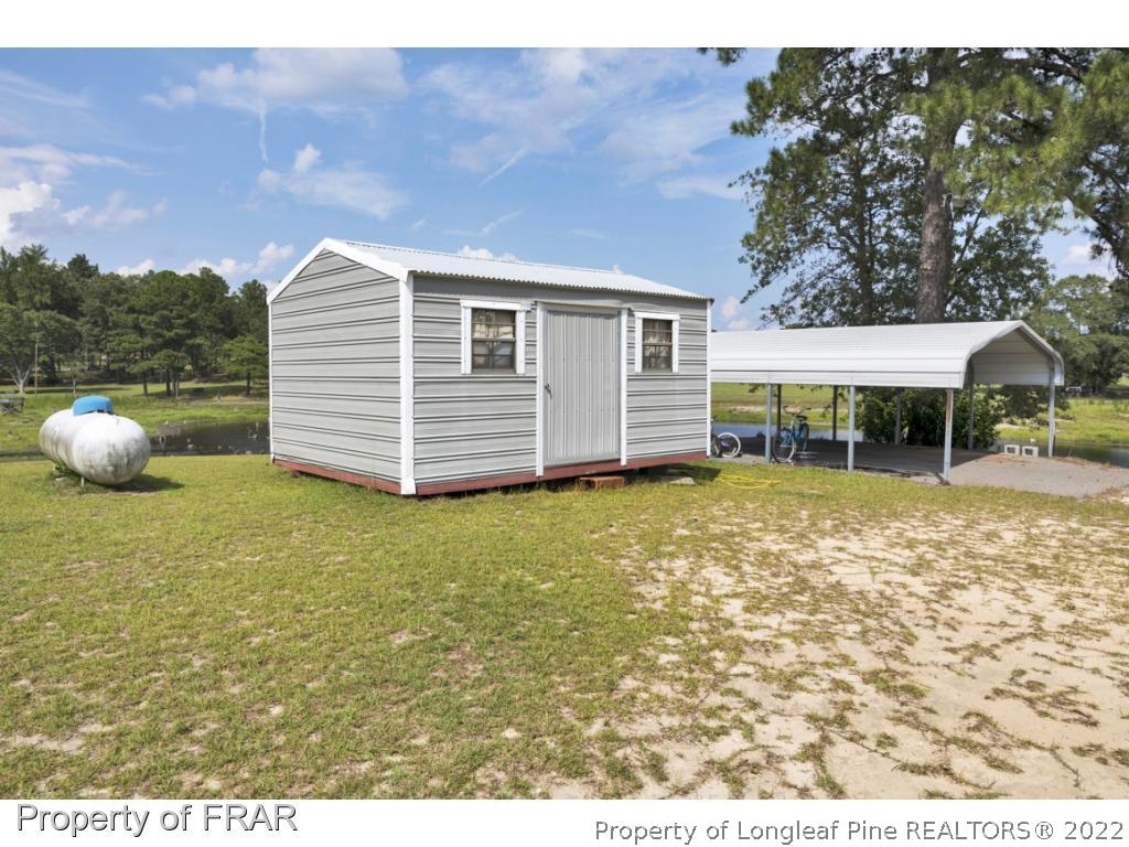 5253 Lobelia Road Vass, NC 28394 - Photo 23 of 28 a front view of a house with a garden