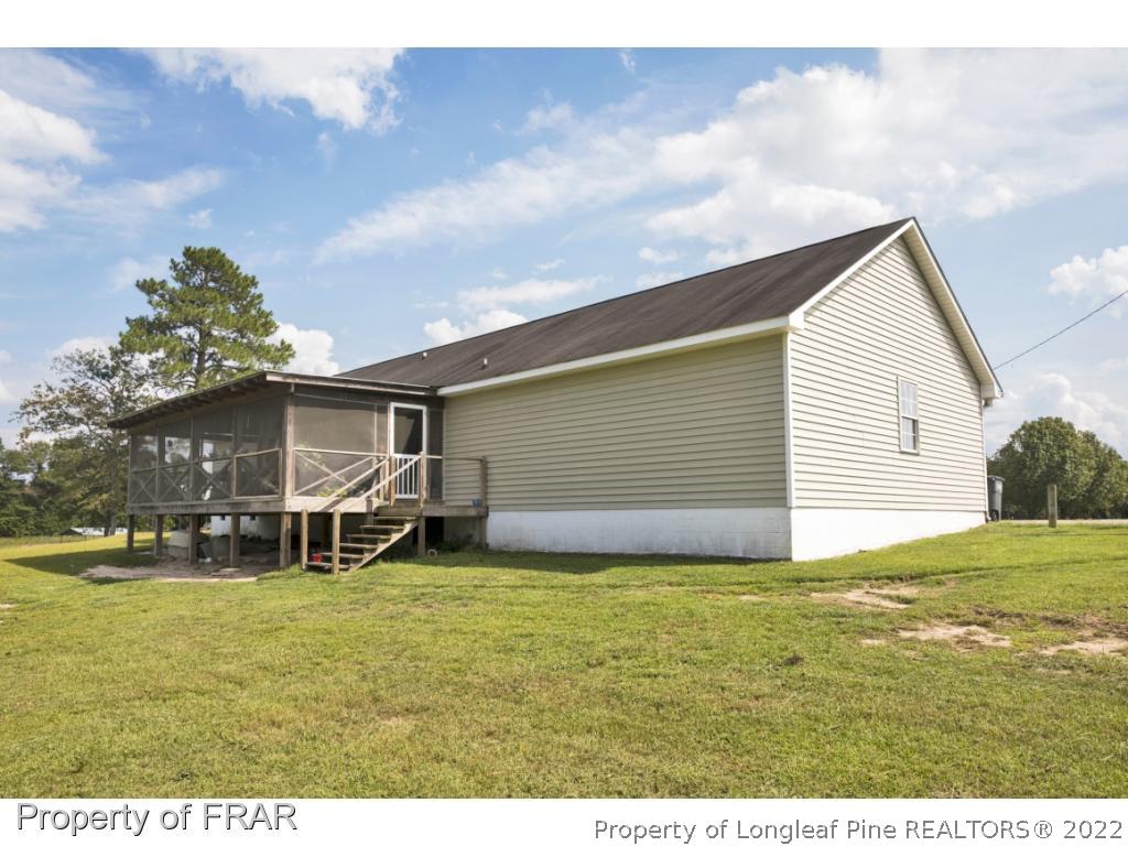 5253 Lobelia Road Vass, NC 28394 - Photo 26 of 28 a view of a house with a yard