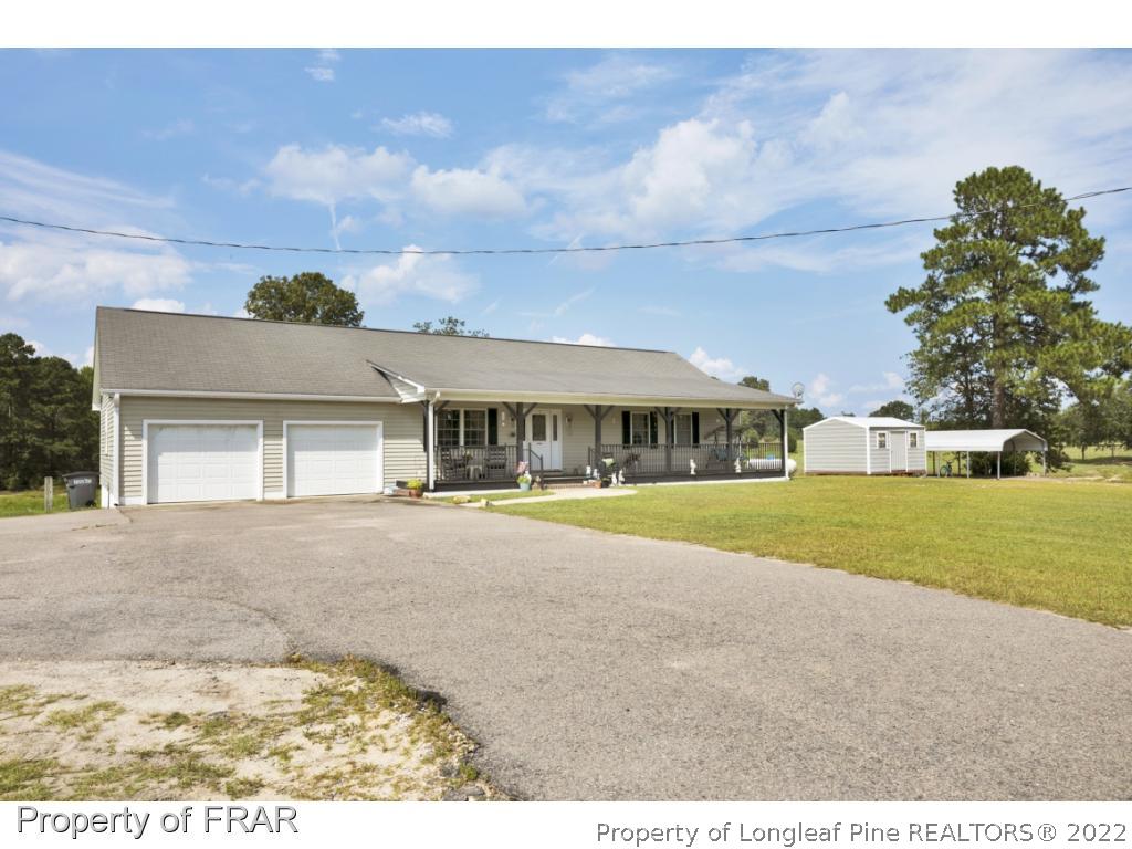 5253 Lobelia Road Vass, NC 28394 - Photo 28 of 28 a front view of house with yard and car parked