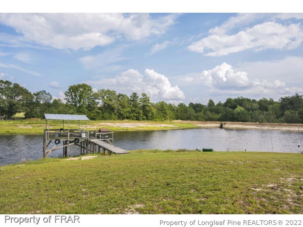 5253 Lobelia Road Vass, NC 28394 - Photo 4 of 28 a view of a lake with a big yard
