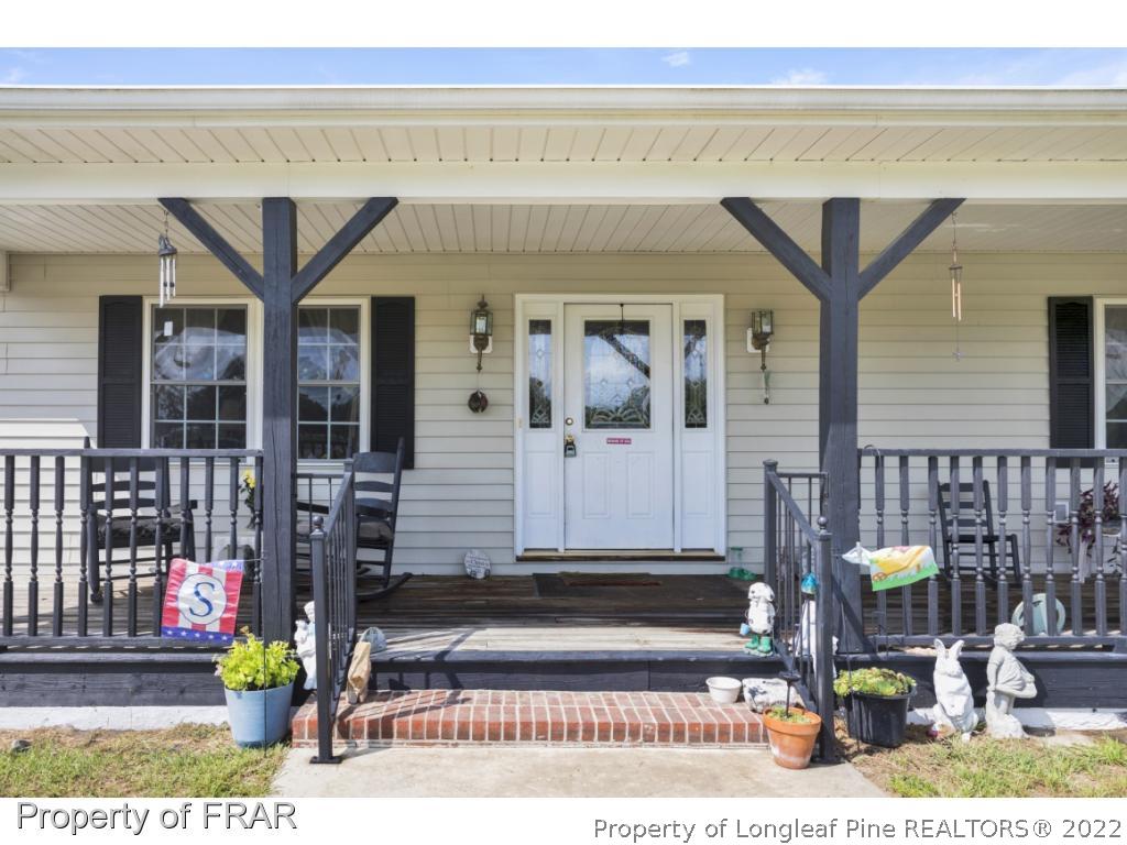 5253 Lobelia Road Vass, NC 28394 - Photo 6 of 28 a view front of building with glass door and outdoor seating