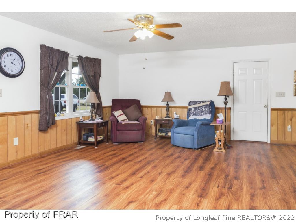 5253 Lobelia Road Vass, NC 28394 - Photo 8 of 28 a living room with furniture and a wooden floor