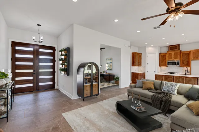 a living room with furniture a wooden floor and white walls