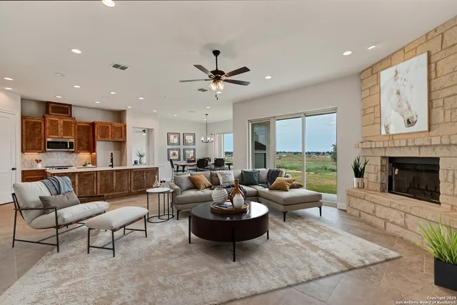 a living room with furniture dining table a fireplace and a window