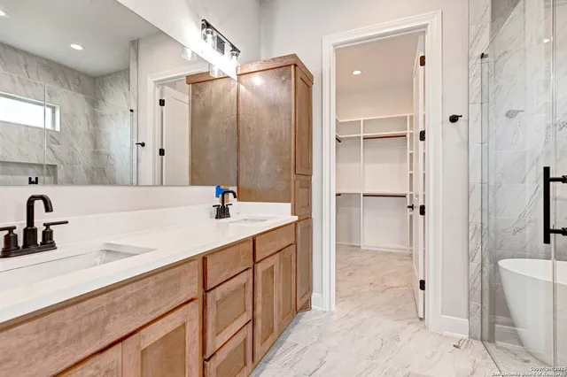 a bathroom with a granite countertop sink mirror and double