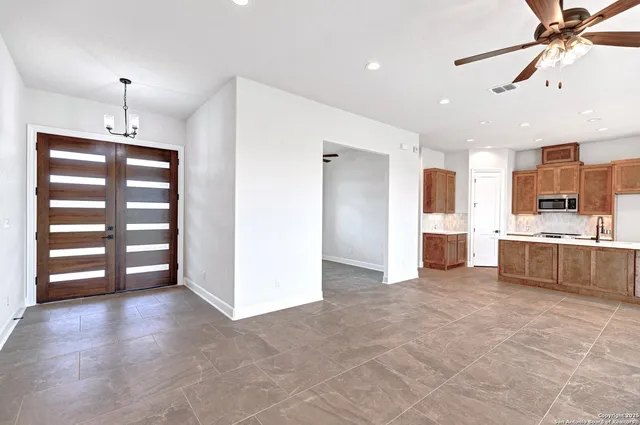 a view of kitchen with stainless steel appliances cabinets and wooden floor