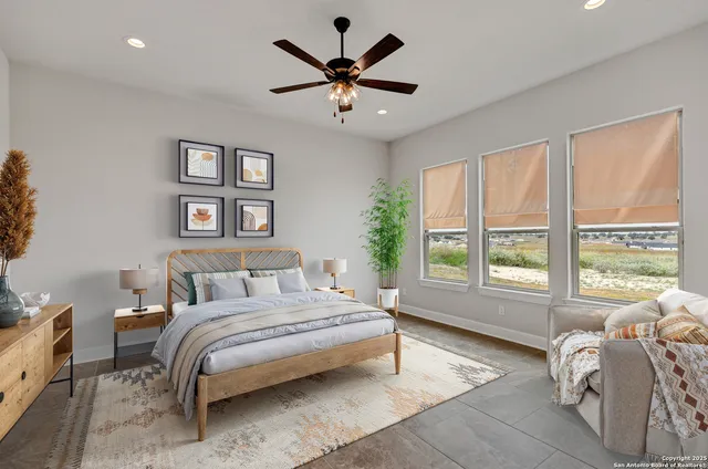 a bedroom with a bed and a large window