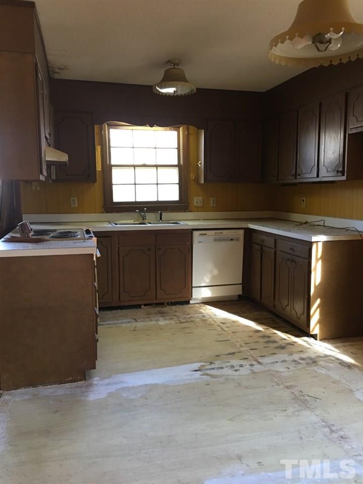 3312 Boulder Court Raleigh, NC 27607 - Photo 3 of 9 a large kitchen with stainless steel appliances granite countertop a stove a sink and a microwave
