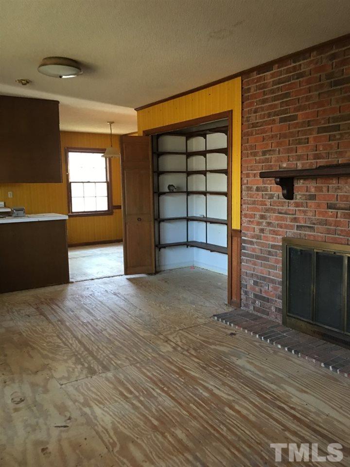 3312 Boulder Court Raleigh, NC 27607 - Photo 5 of 9 a view of a livingroom with a fireplace and window