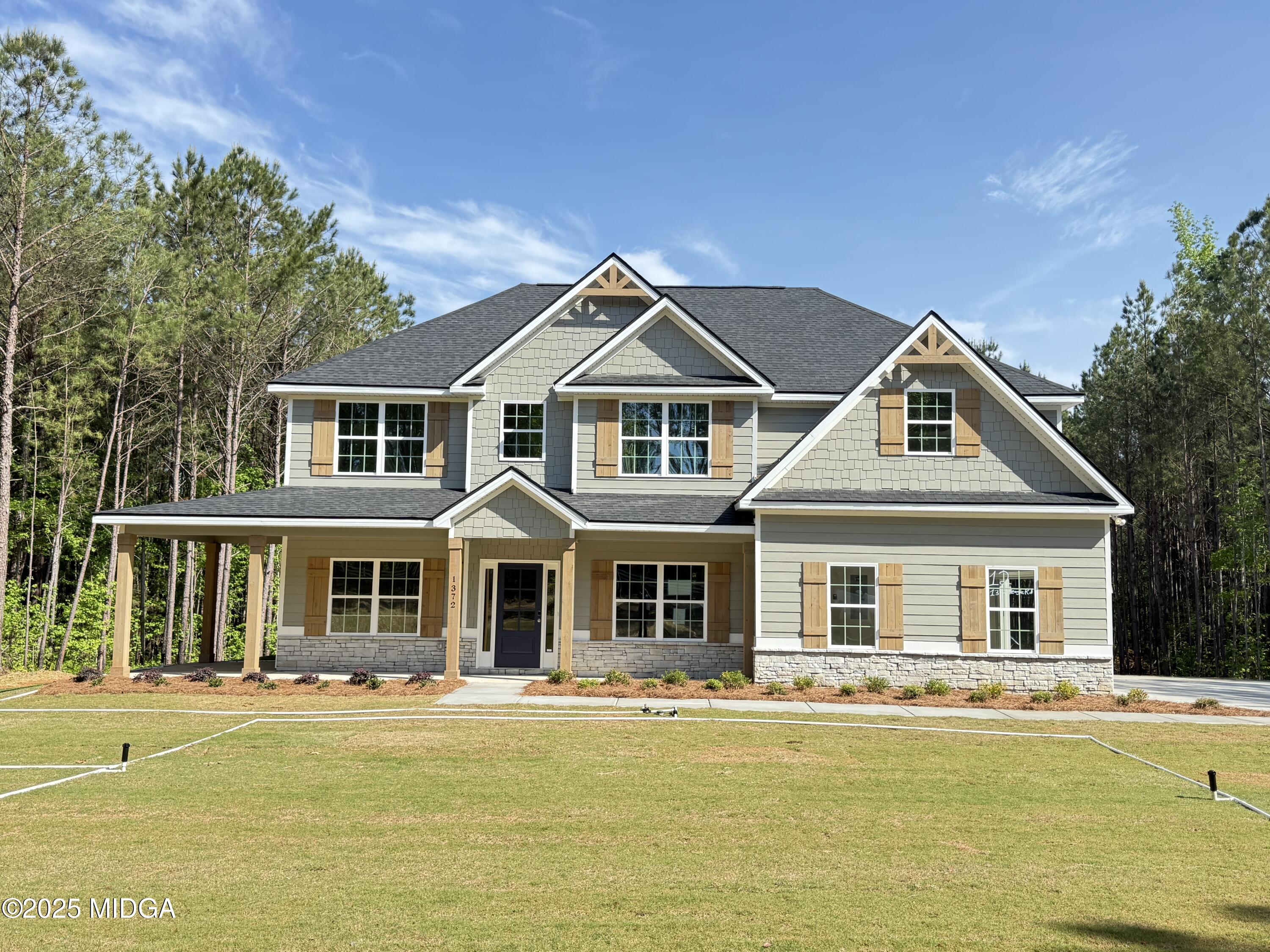 1372 Teagle Road, Unit 12 Forsyth, GA 31029 - Photo 1 of 1 a front view of a house with swimming pool and porch