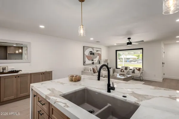 a kitchen with a sink a counter space and a window