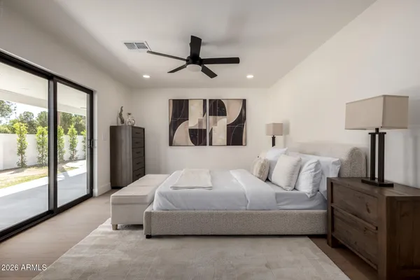 a bed room with a bed and a night stand