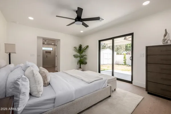 a bedroom with a large bed and a window