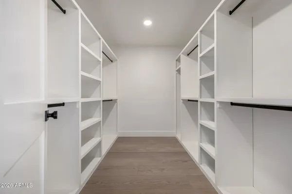 a view of walk in closet with empty racks