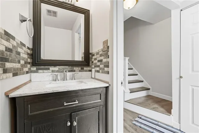 a bathroom with a sink and a mirror