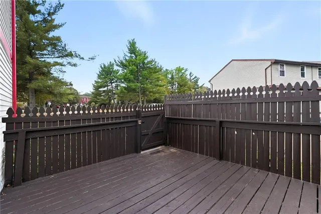 a terrace with wooden floor and fence