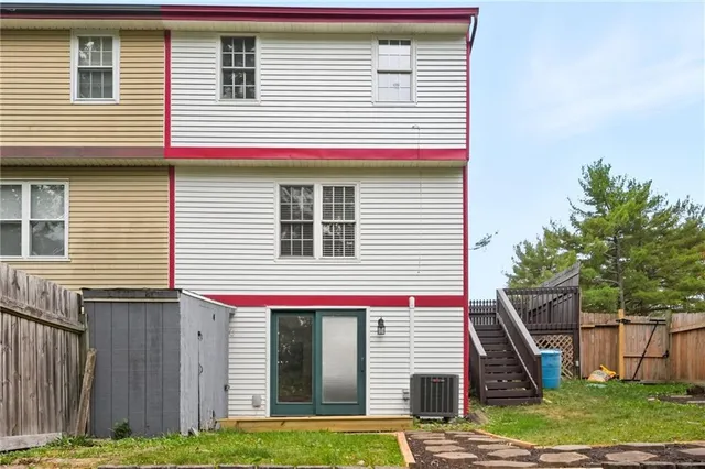 a view of a house with a yard and stairs
