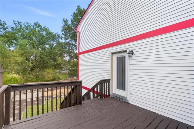 a view of a balcony with wooden floor and fence