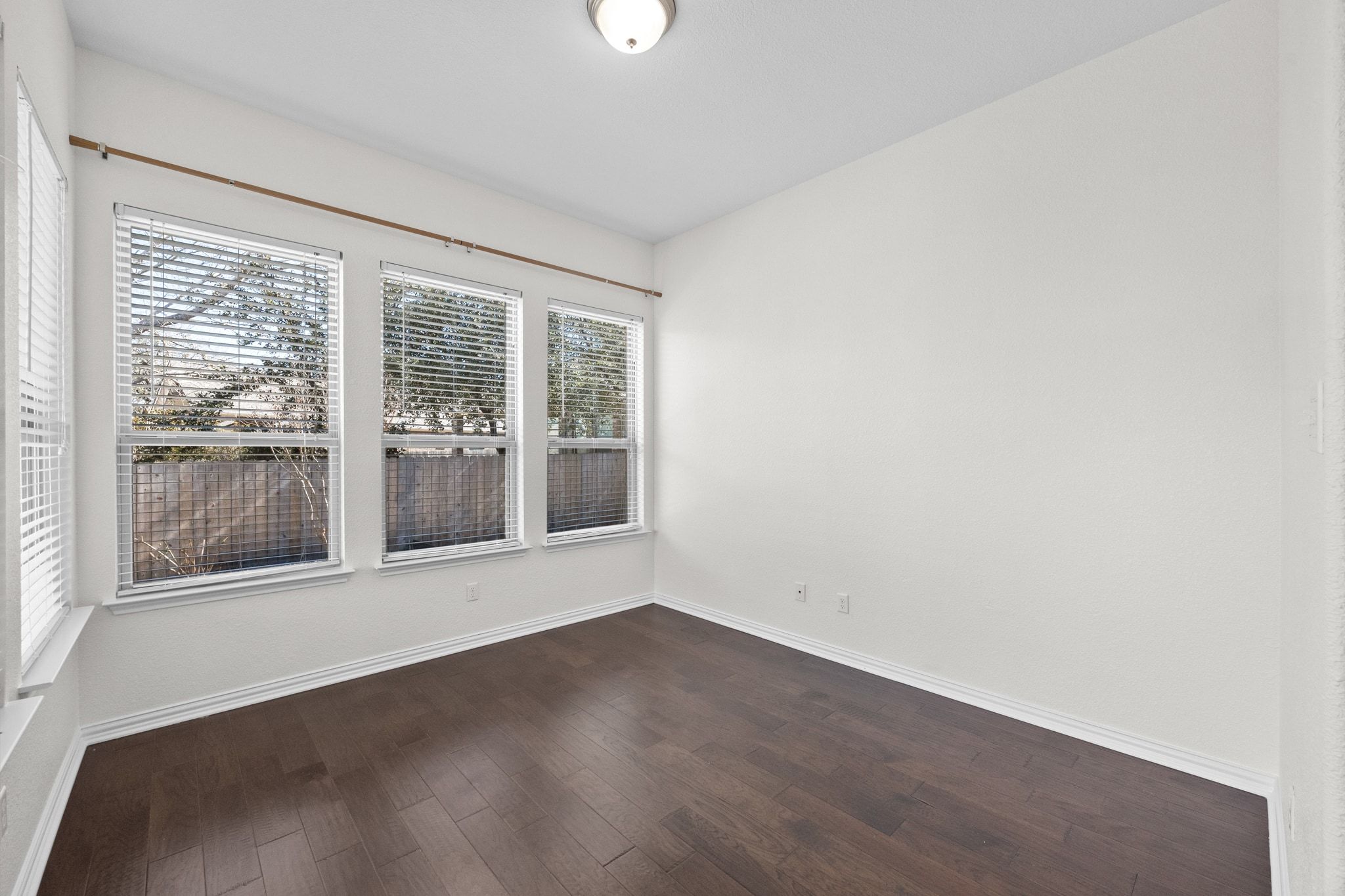 228 Sangiovese Leander, TX 78641 - Photo 12 of 32 an empty room with wooden floor and windows