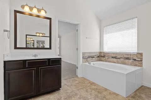 an empty room with closet and windows