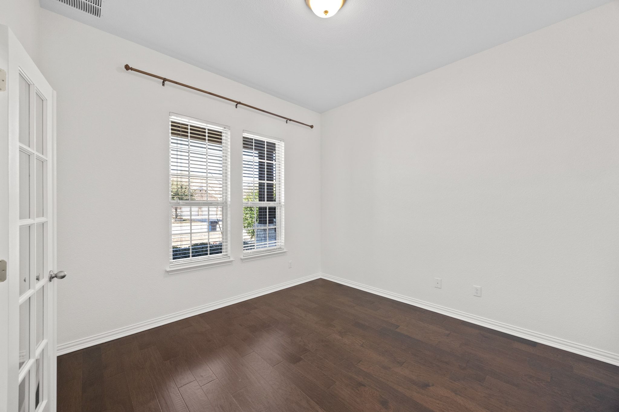 228 Sangiovese Leander, TX 78641 - Photo 19 of 32 an empty room with wooden floor and windows