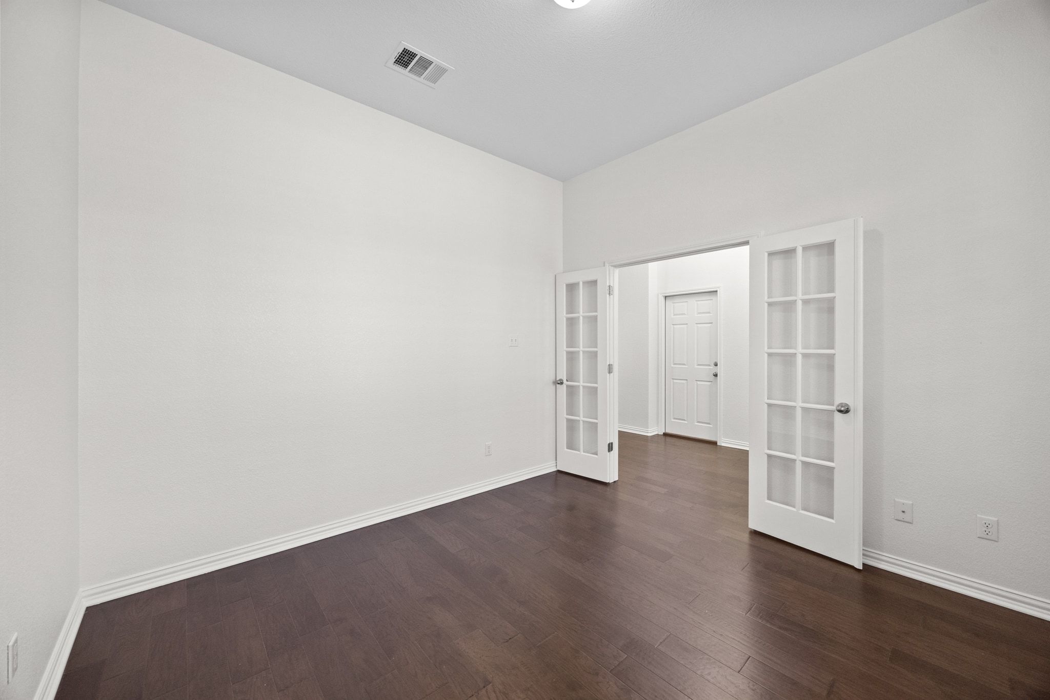 228 Sangiovese Leander, TX 78641 - Photo 20 of 32 an empty room with wooden floor and windows